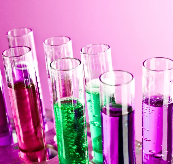 Test tubes on pink background — Stock Photo, Image