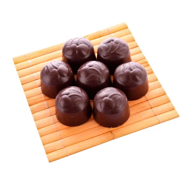 Chocolade op houten oppervlak geïsoleerd — Stockfoto