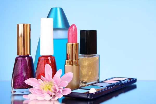 Cosmetics on blue background — Stock Photo, Image