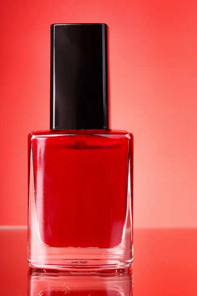 Nail varnish on red background — Stock Photo, Image