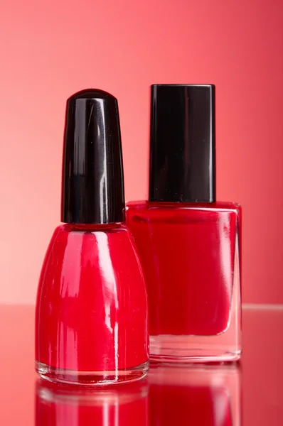 Nail polishes on red background — Stock Photo, Image