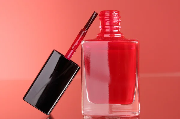 Pink nail polish on red background — Stock Photo, Image