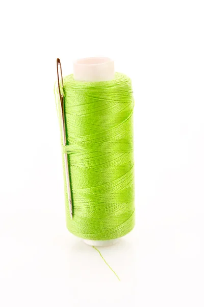 Green Bobbin with needle isolated on white — Stock Photo, Image