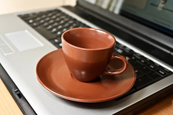 Cup on laptop keyboard — Stock Photo, Image