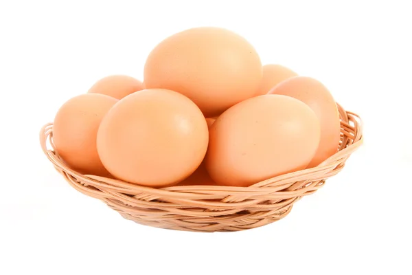 Group of brown hen's eggs in the braided backet isolated in whit — Stock Photo, Image