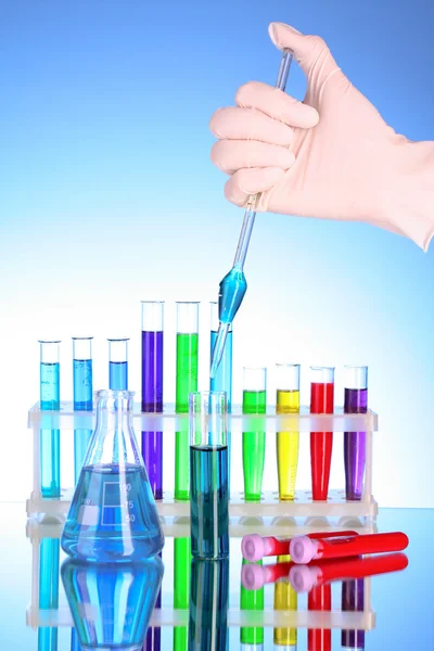 Test tubes over blue background — Stock Photo, Image