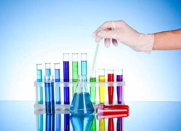 Test tubes over blue background — Stock Photo, Image