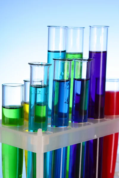 Test tubes on blue background — Stock Photo, Image