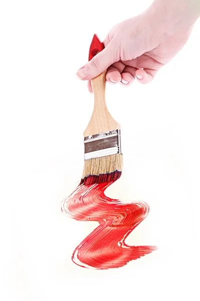 Hand with brush and red paint isolated on white — Stock Photo, Image