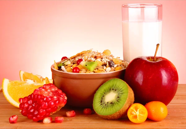 Muesli, milk and fruits on red background — Stock Photo, Image