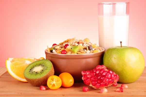 Muesli, milk and fruits on red background — Stock Photo, Image
