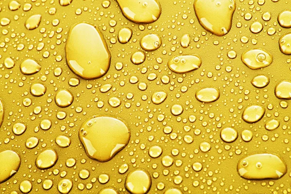 Guld vatten droppar bakgrund — Stockfoto