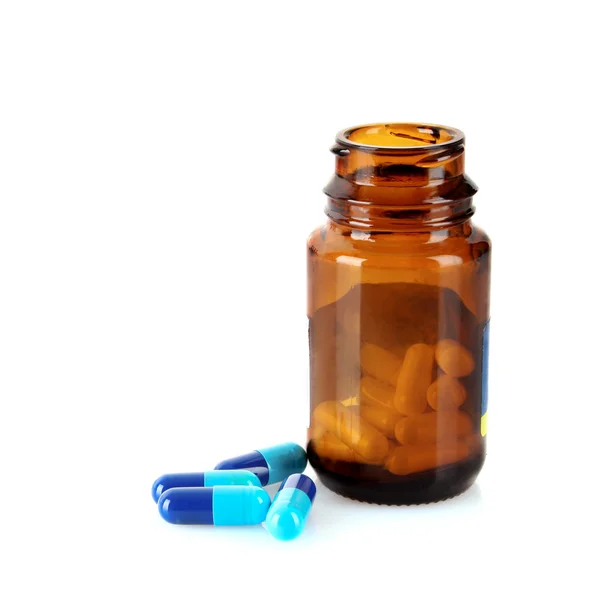 Tablettenflasche mit farbigen Pillen isoliert auf weiß — Stockfoto