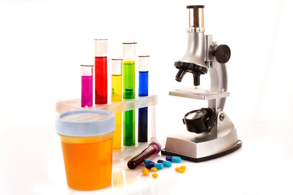 Laboratory metal microscope and test tubes with liquid isolated — Stock Photo, Image