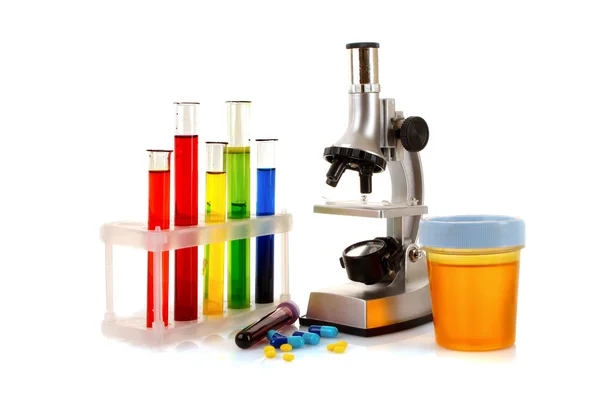 Laboratory metal microscope and test tubes with liquid isolated — Stock Photo, Image