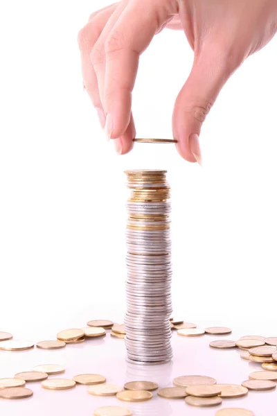 Someone add coin to coin tower Stock Photo