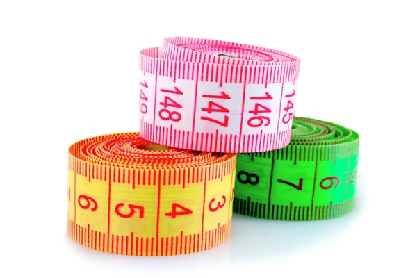 Multicoloured measuring tapes isolated on white Royalty Free Stock Images