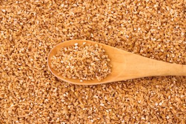 Fine-ground barley with spoon as texture clipart