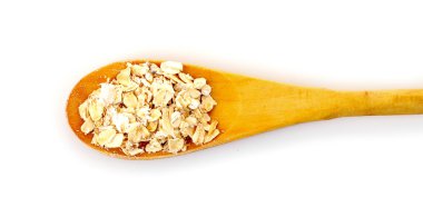 Uncoocked rolled oats in wooden spoon isolated on white clipart