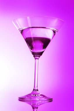 Martini glass on purple background clipart