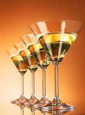 Four martini glasses on yellow background clipart