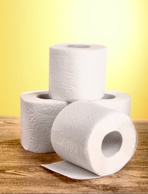 Toilet pape on yellow background clipart