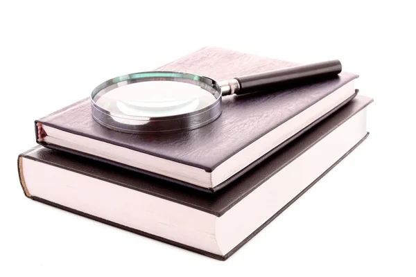 Hard cover book and magnifier isolated on white — Stock Photo, Image
