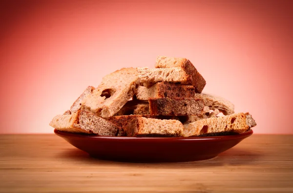 Rusk on red background — Stock Photo, Image