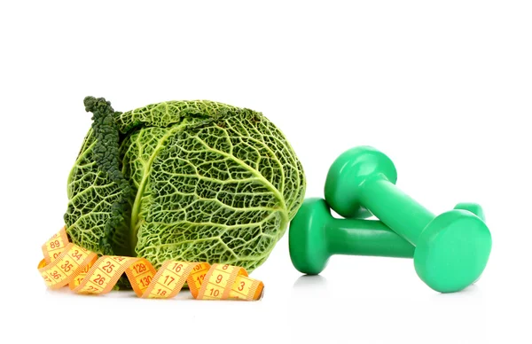 Savoy cabbage, dumbbells and measure tape on white background — Stock Photo, Image