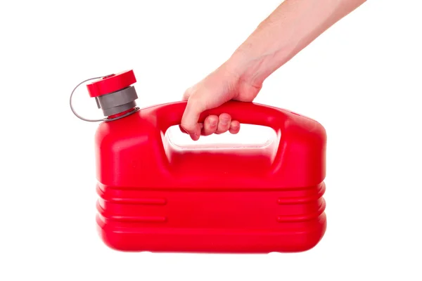 Tanica carburante in plastica rossa in mano isolata su bianco — Foto Stock