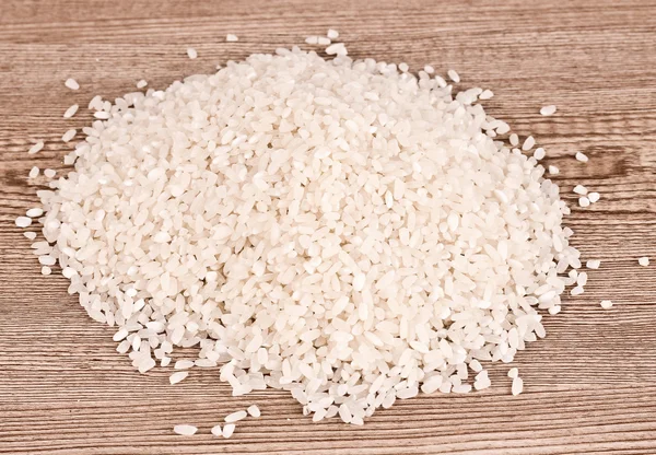 Rice on wooden table — Stock Photo, Image