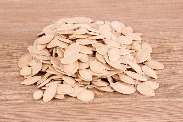 Pumpkin seeds on brown — Stock Photo, Image