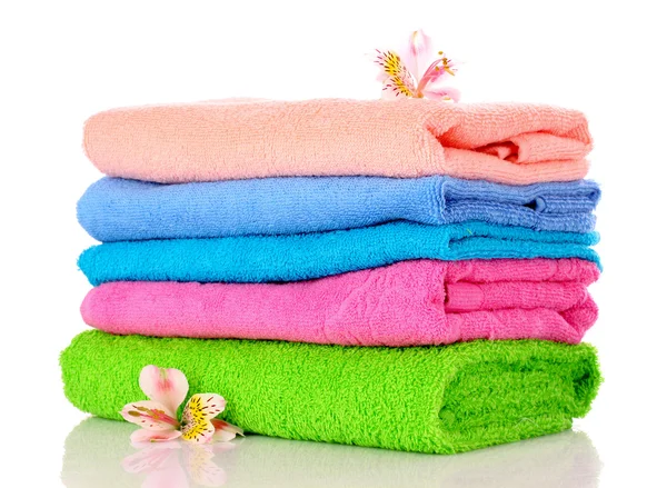 Few towels and flowers isolated on white — Stock Photo, Image