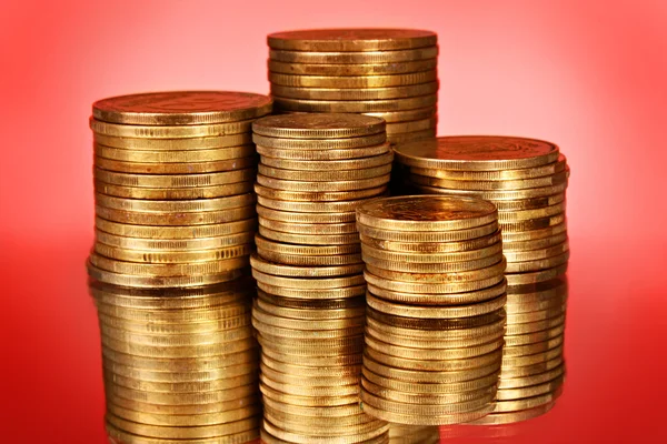 Coins on red background — Stock Photo, Image