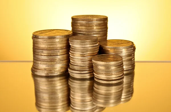 Coins on yellow background — Stock Photo, Image