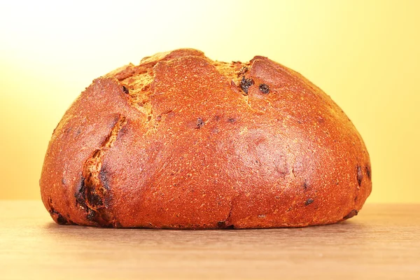Fresh wheat bread on yellow background — Stock Photo, Image