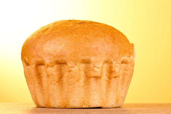 Fresh wheat bread on yellow background — Stock Photo, Image