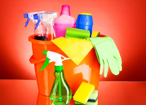 Cleaning supplies on red background — Stock Photo, Image