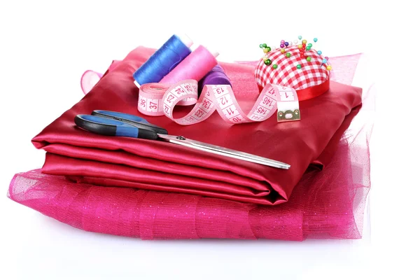 Rood, blauw en roze draad, meten tape en stof — Stockfoto