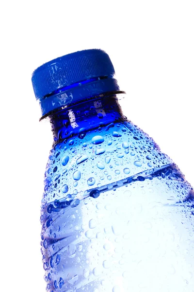 Garrafa de água com gotas de água no fundo azul — Fotografia de Stock