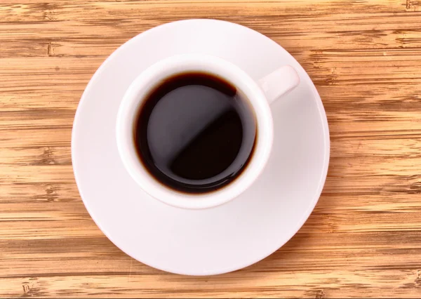Koffiekopje op houten oppervlak — Stockfoto