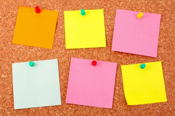 Six colorful stickers pinned to a cork board — Stock Photo, Image