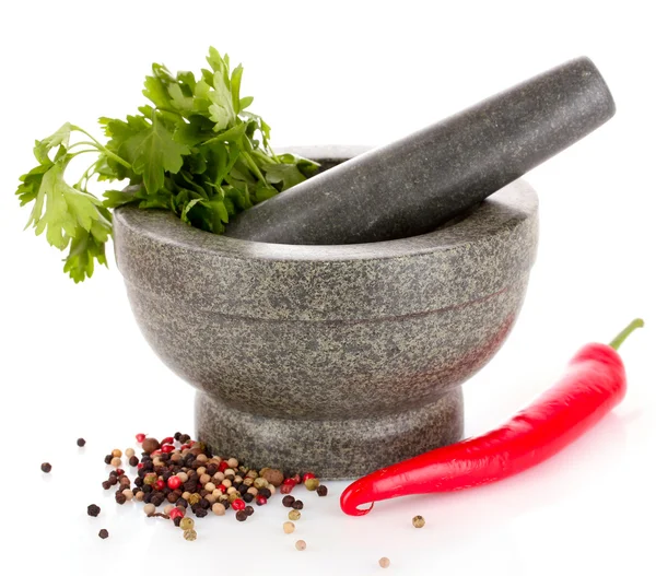 Mortar and pestle, parsley and pepper isolated on white — Stock Photo, Image