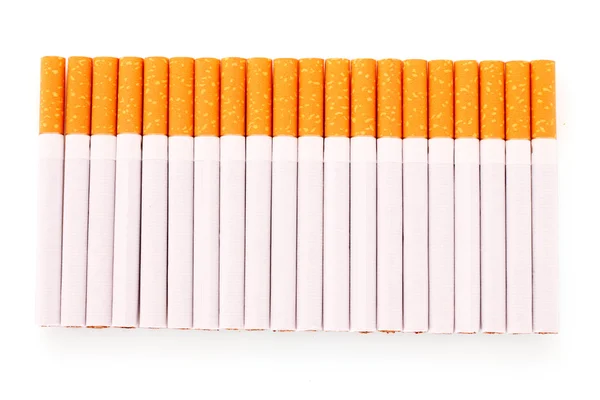 Många cigaretter isolerade på vitt — Stockfoto