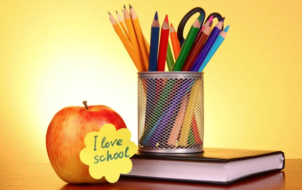 Brevpapper och äpple med "Jag älskar skolan" på gul bakgrund — Stockfoto