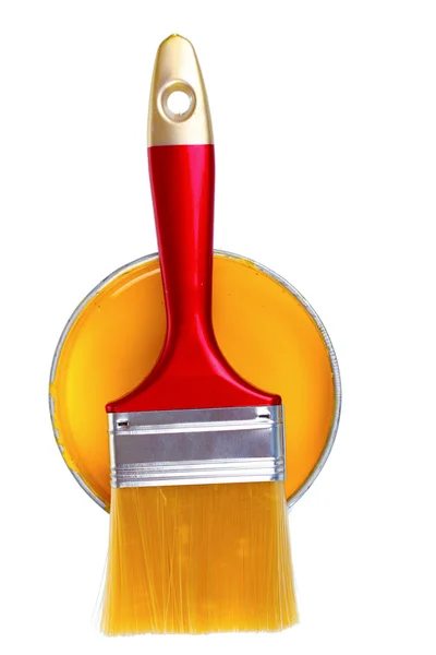 Open can of yellow paint and brush — Stock Photo, Image