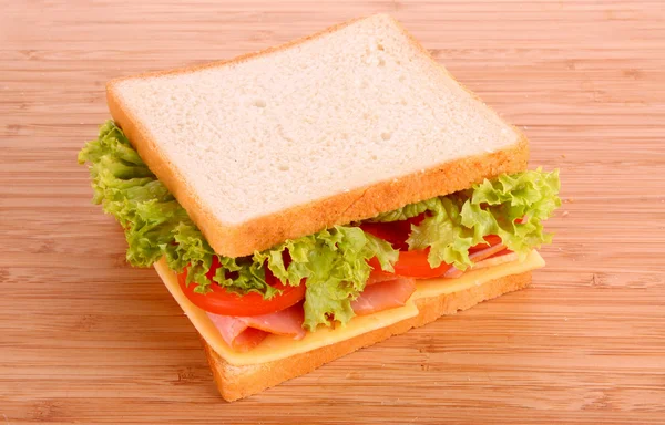 Sandwich on wooden plate — Stock Photo, Image