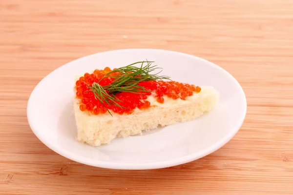 stock image Red caviar and bread on wooden table