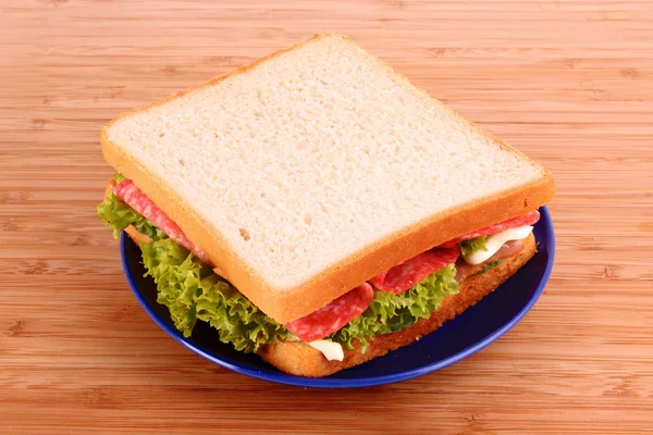 Sandwich on wooden plate — Stock Photo, Image