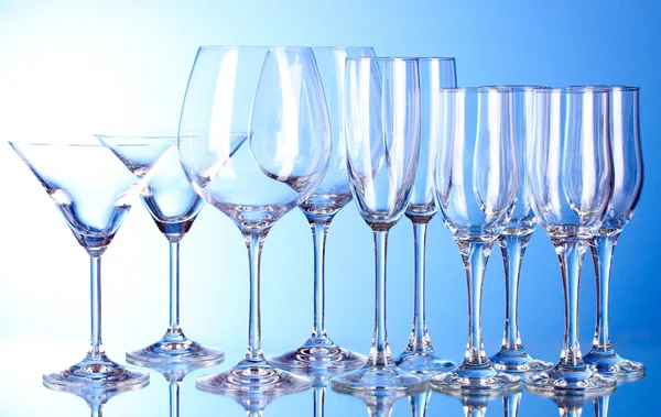 Несколько пустых бокалов вина на синем фоне — стоковое фото